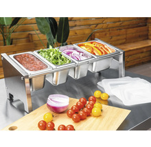 Behållare för tillbehör i rostfritt stål med fyra fack, fyllda med färska grönsaker och sås på ett arbetsbord.