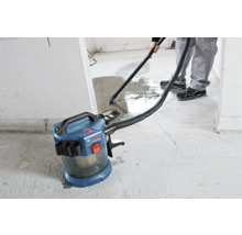 Bosch Professional sladdlös våt- och torrdammsugare vid uppsugning av vatten från ett betonggolv.