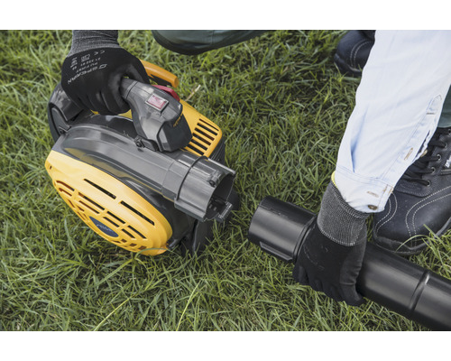 En gul lövsug monteras på en gräsmatta.