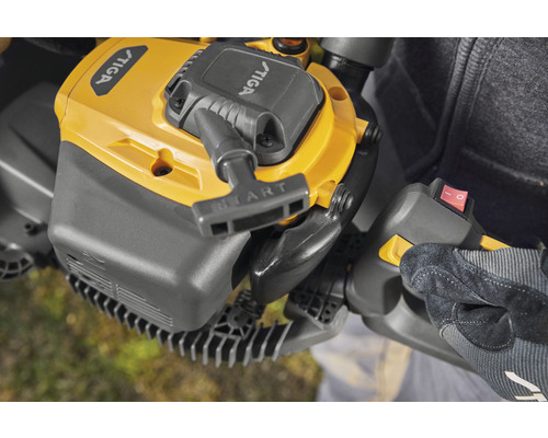 Detaljbild av en häcksax med startknapp och strömbrytare