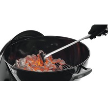 Klotgrill med glödande kol och grillverktyg