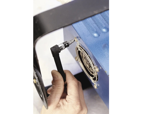 En person fäster en skruvmejsel på en kylfläns.