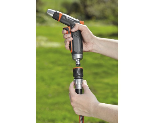 Trädgårdsslanganslutning med Gardena sprutpistol i handen