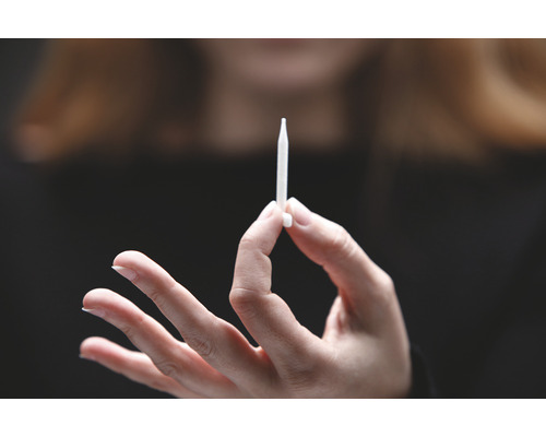 En hand håller en injektor.