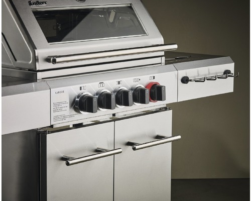 Detalj av gasolgrill med kontrollknappar och dörrar