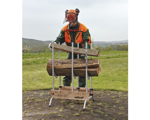 Man fyller en vedstapel från Wolfcraft med träbitar.
