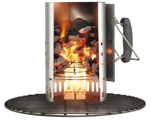 Grilltändare med glödande kol och grillgaller