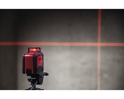 Korslinjelaser på stativ med laserlinjer på väggen