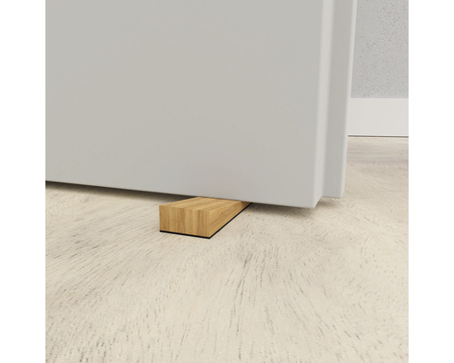 Dörrstopp av trä under en dörr