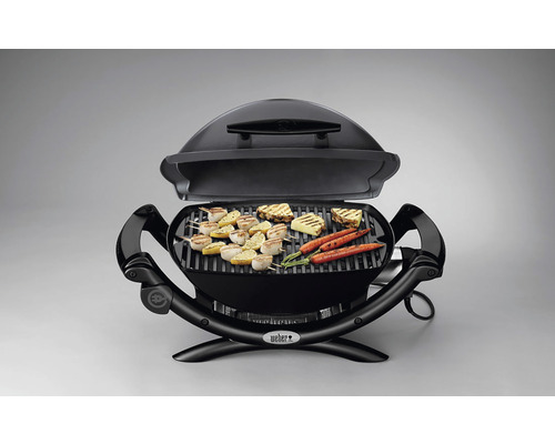 Öppen svart elektrisk grill med grillad mat