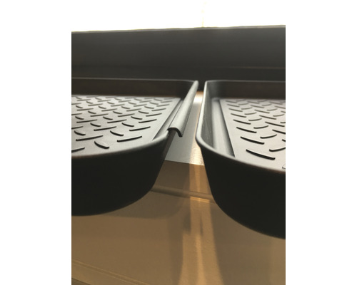 Två svarta skobrickor i plast med räfflat mönster