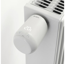 Elektronisk radiatortermostat med digital display och Zigbee-logotyp på radiatorn