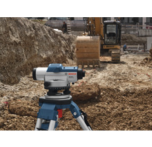 Bosch logotyp. Byggarbetsplats med avvägningsinstrument på stativ och grävmaskin i bakgrunden.