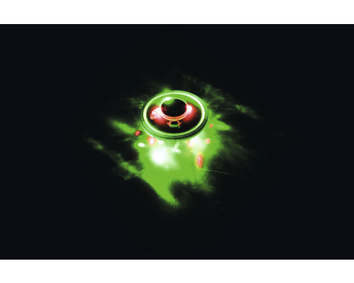 Cirkelformat objekt med grön sken och rött centrum