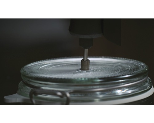 En glasburk bearbetas med ett roterande verktyg