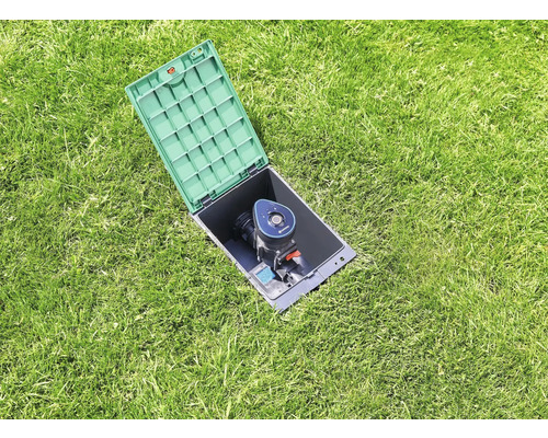 Pop-up sprinkler med öppet hölje i gräsmattan