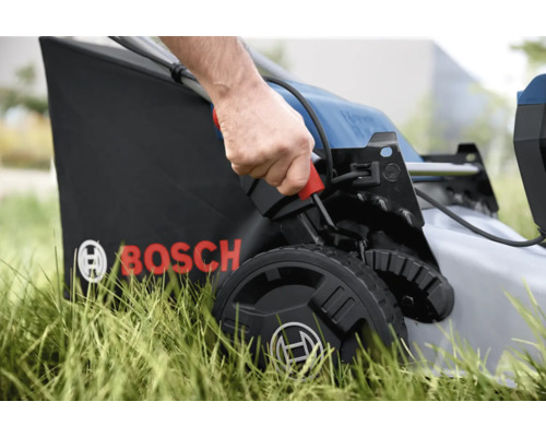 Detaljbild av en gräsklippare i drift med uppsamlingskorg och Bosch-logotyp
