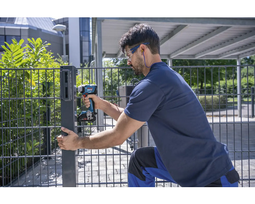 Man monterar en staketstolpe med en sladdlös skruvdragare.