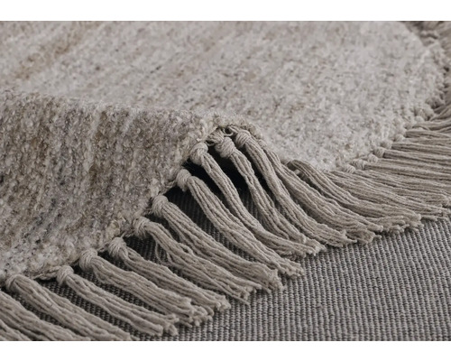 Detalj av en rund matta med fransar