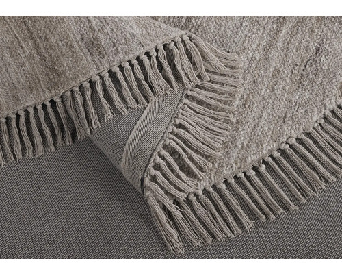 Detalj av en matta med fransar