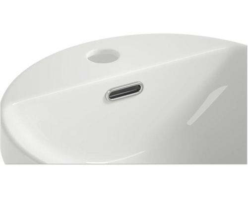 Detaljvy av ett tvättställ med överlopp