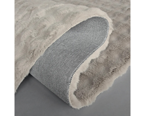 Grå matta med luggyta och tygbaksida