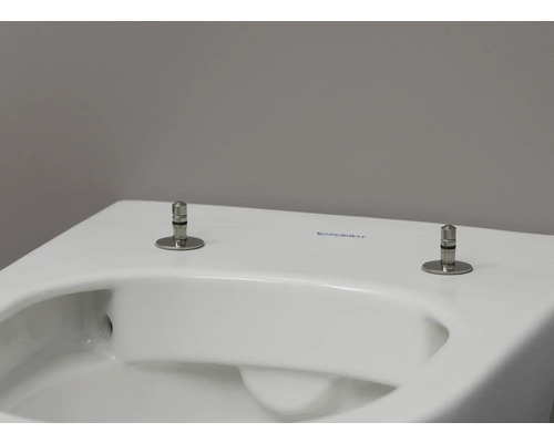 Detaljvy av en toalett med toalettsitsfäste