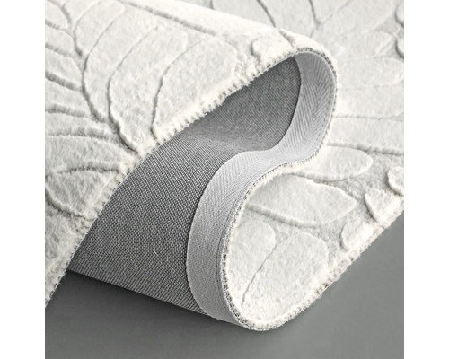 Detaljvy av en vit matta med bladmönster