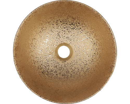 Överifrån av ett runt handfat av guldfärgat material med avloppshål