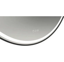 Detaljvy av en rund spegel med ljus och kontrollpanel