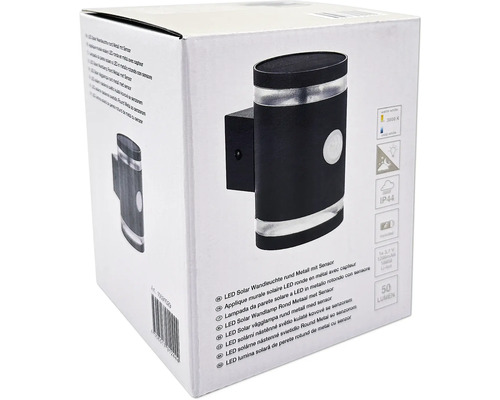 Förpackning av en rund solcellsdriven LED-vägglampa av metall med sensor