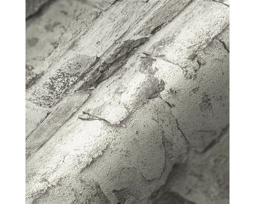 Närbild av en rulle tapet med stenmönster.