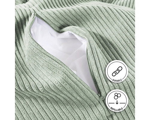 "Närbild av en sittpuff i manchester med öppen dragkedja som visar fyllningen