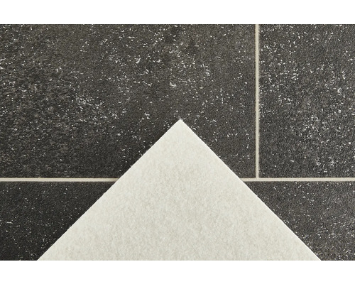 Närbild av ett vinylgolv med stenutseende och vit baksida