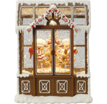 Dekorativ snöglob i form av ett pepparkakshus med pepparkaksgubbar