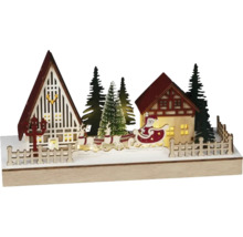 Juldekoration med jultomten, renar, hus och träd