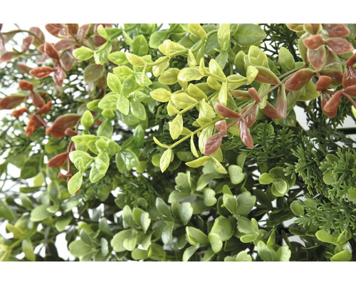 Närbild av konstgjorda växter med gröna och bruna blad