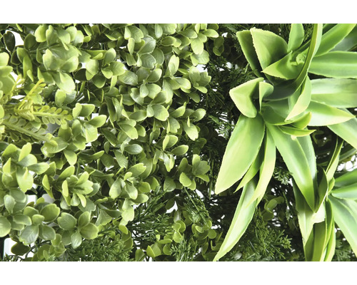 Konstgjord grön växtvägg med olika bladstrukturer.