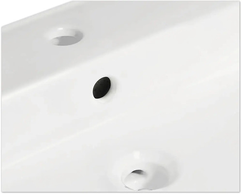 Detalj av ett tvättställ med överlopp