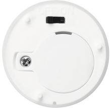 Undersida av en rund LED-lampa med batterifack och strömbrytare