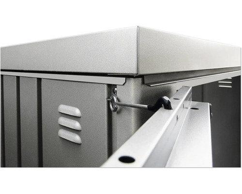 Detaljvy av ett metallredskapsskåp med ventilationsöppningar och stängningsmekanism.