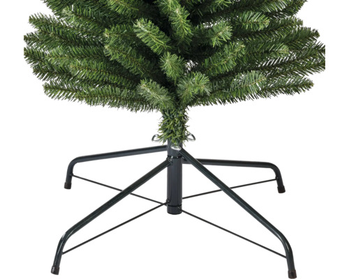 Närbild av en konstgjord julgran med metallstativ