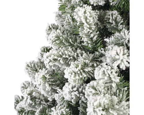 Närbild av en konstgjord, snötäckt julgran