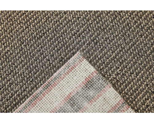 Detaljvy av en tuftad matta med textilbaksida