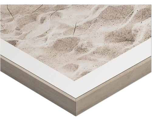 Detaljvy av en inramad väggdekoration med sandmotiv