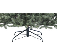 Närbild av en konstgjord julgran med metallfot