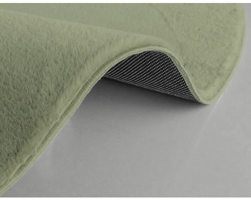 Detaljvy av en matta med lugg och halkfri undersida.