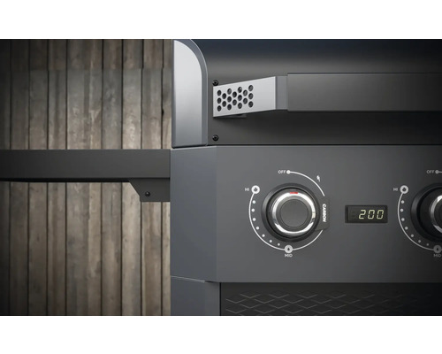 Detaljvy av en kolgrill med temperaturregulator och digital display