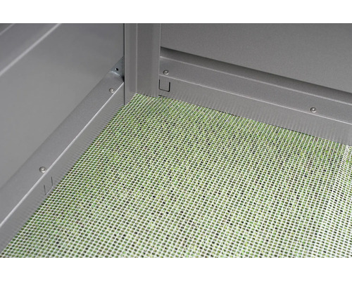 Detaljvy av ett trädgårdsskjul med golvgaller