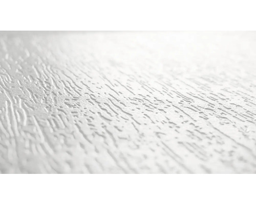 Närbild av en vit putsyta med oregelbunden struktur